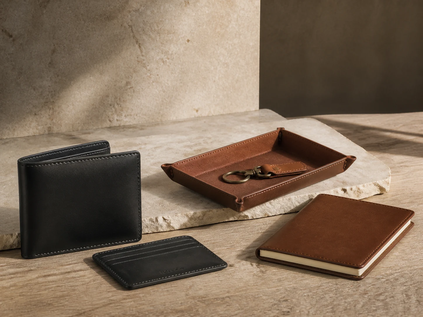 A curated group of leather goods on a neutral work surface